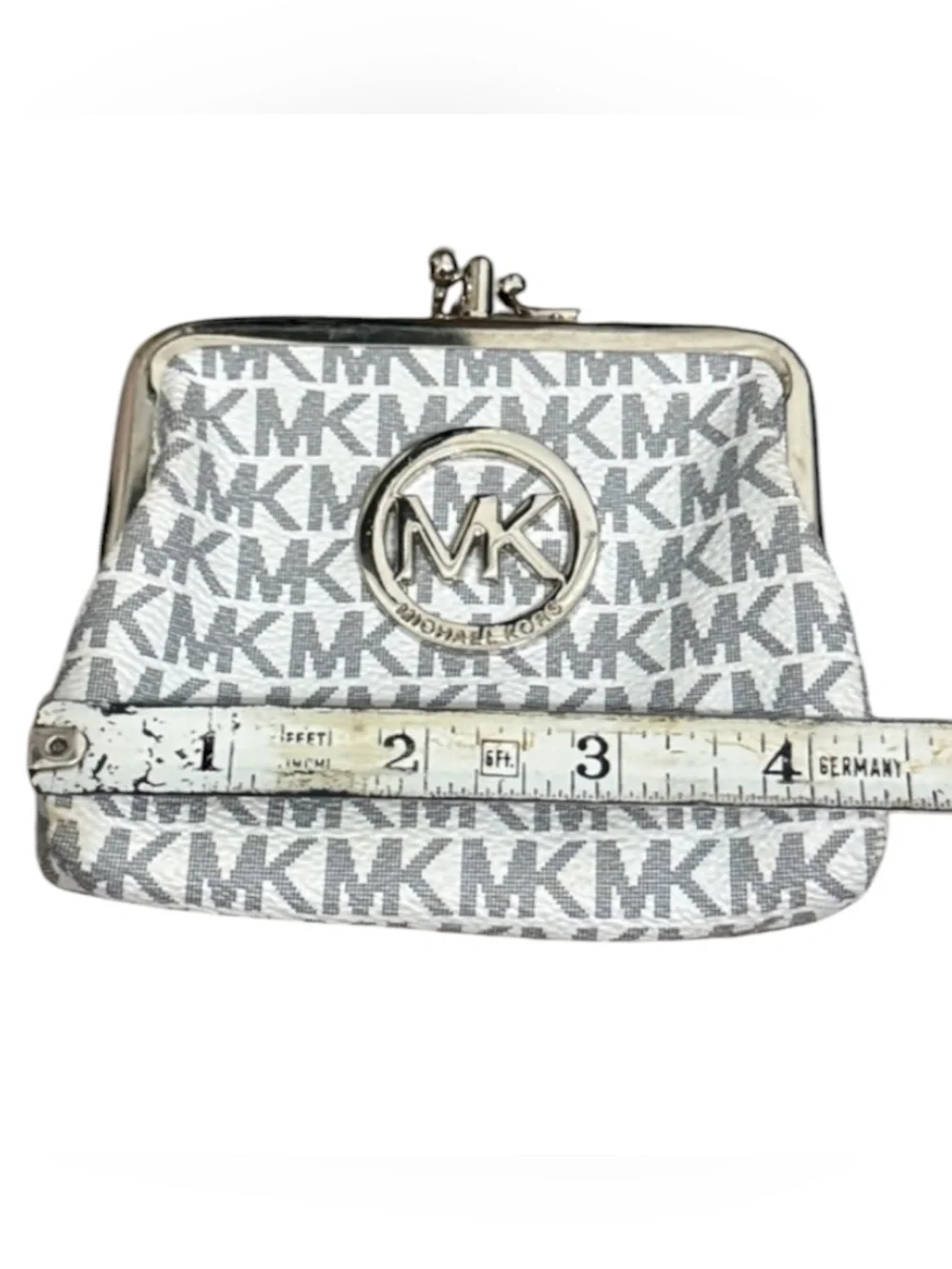Michael Kors signature white and gray change purse with a clasp closure